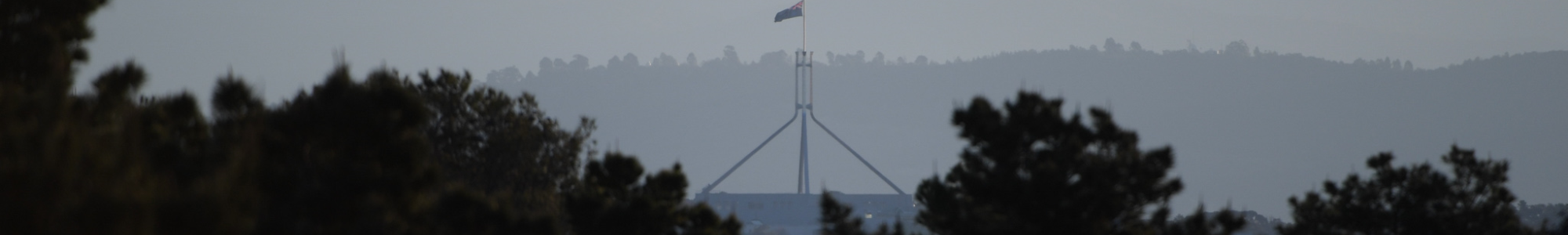 Parliament House stands from afar